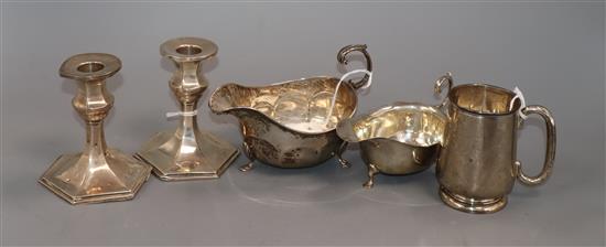 A pair of George V silver dwarf pillar candlesticks (weighted), two silver sauce boats and a Christening mug, 8.5oz (weighable)